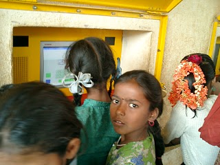 Sugata Mitra's hole-in-the-wall experiment; some children using a computer embedded into a wall.